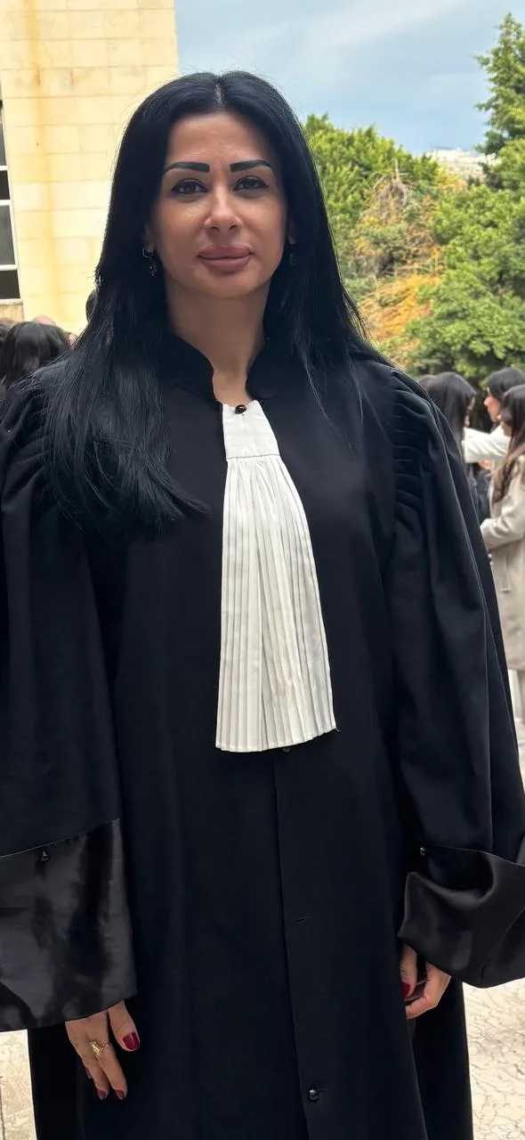 ميرنا نكد برداء المحاماة أمام قصر العدل.